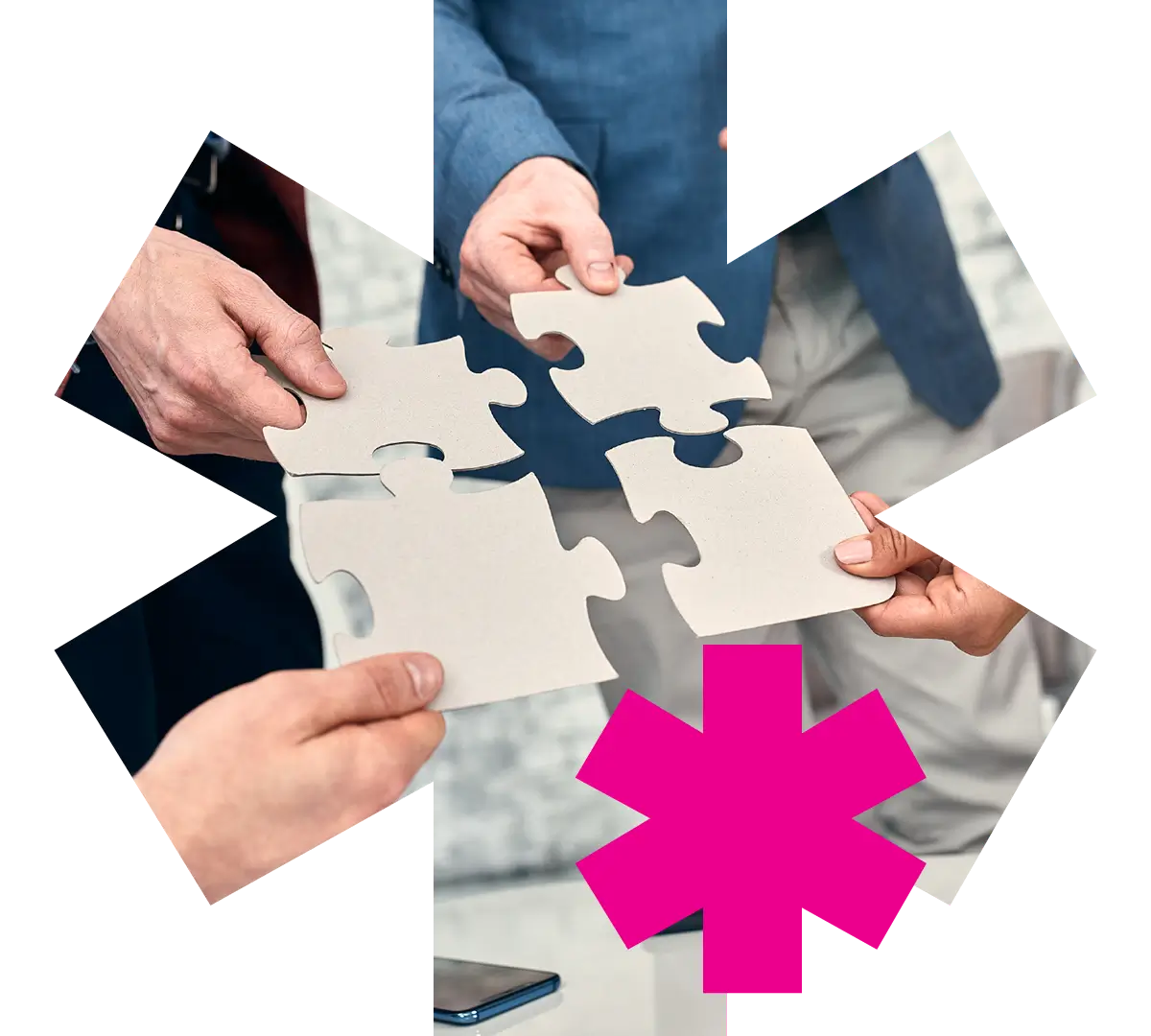 Four hands holding a jigsaw piece and joining them together